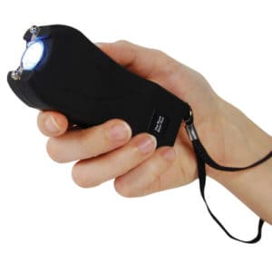 Runt Rechargeable Stun Gun With Flashlight And Wrist Strap Disable Pin in hand view - BLACK