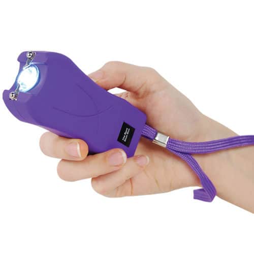 Runt Rechargeable Stun Gun With Flashlight And Wrist Strap Disable Pin in hand view - PURPLE
