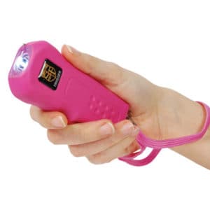 Trigger Stun Gun Flashlight with Disable Pin in hand view - PINK